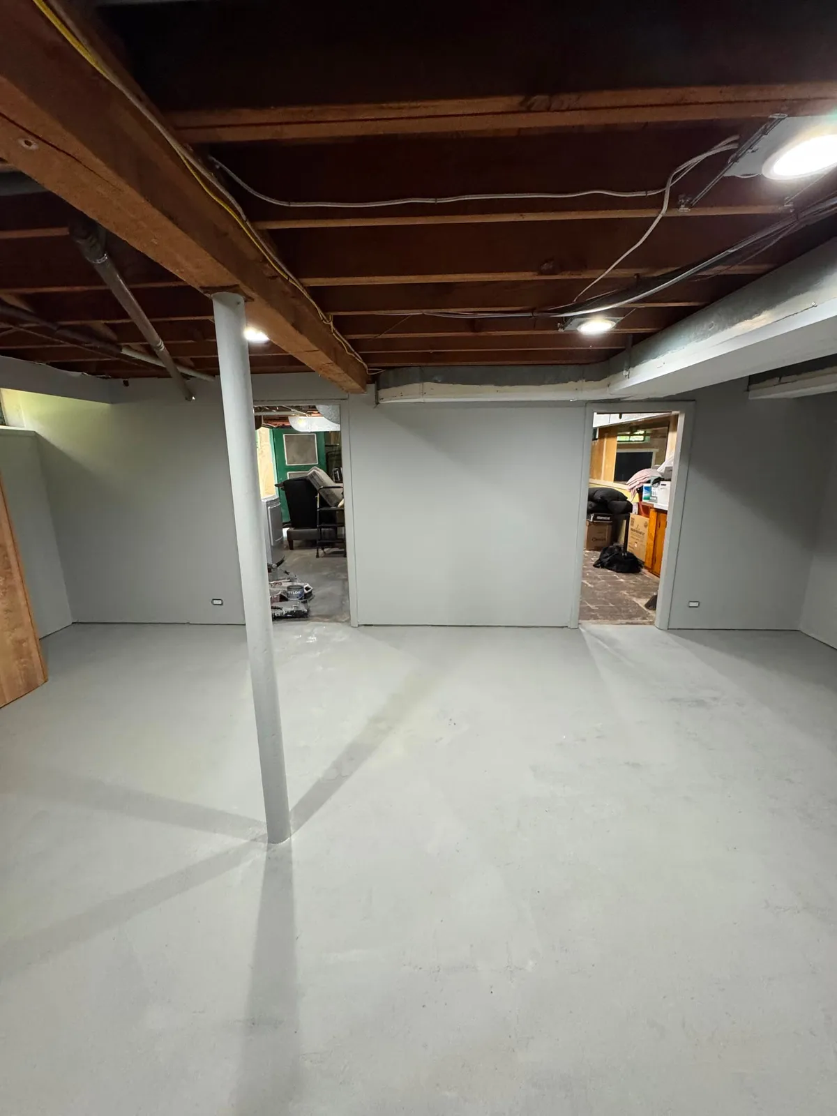 Bright, freshly painted basement after refinishing